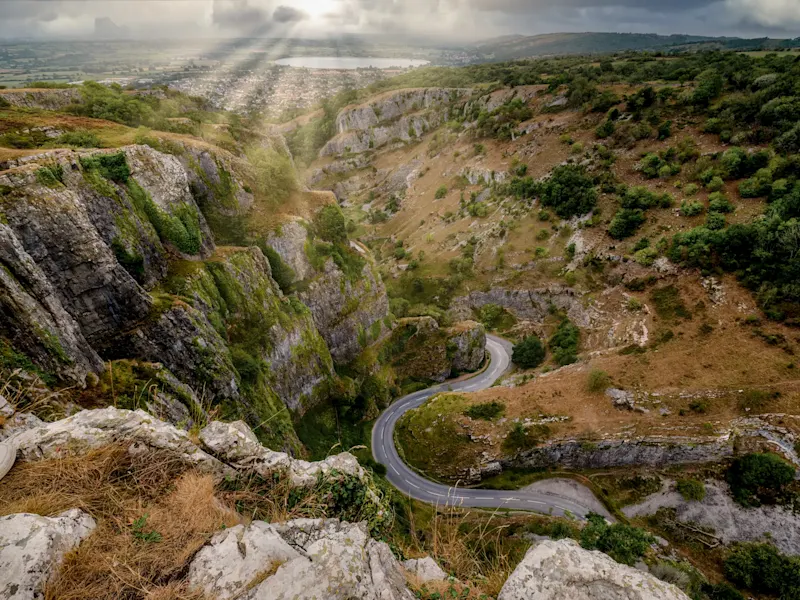Picturesque Cheddar Gorge with steep limestone cliffs and winding road. Somerset, England.