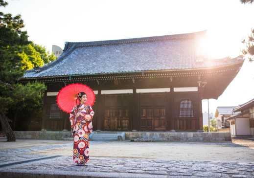 Junge Frau, die in einem Kimono vor einem Hyakumanben Chionji-Tempel posiert. Kyoto, Japan