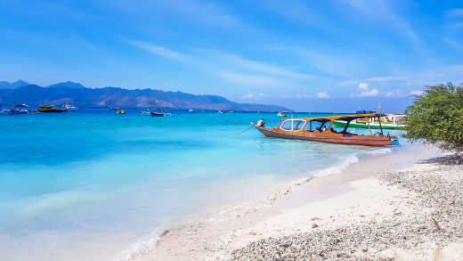 Un bateau au bord du sable blanc, sur la plage à Gili Air, îles Gili, Indonésie.

