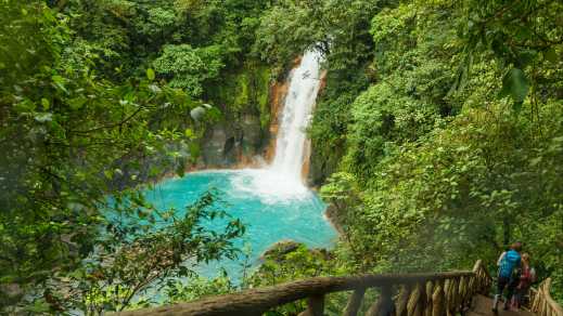 Randonneurs marchant près d'une cascade dans le Parc National Arenal Volcano lors d'un voyage au Costa Rica.