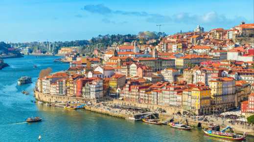 Discover the beautiful Porto skyline, the Douro River, and brightly lit buildings on a tour of Portugal