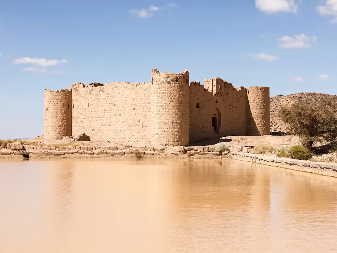 Alte Festung aus Lehmziegeln an einem Wasserbecken. Al Jouf, Saudi-Arabien.
