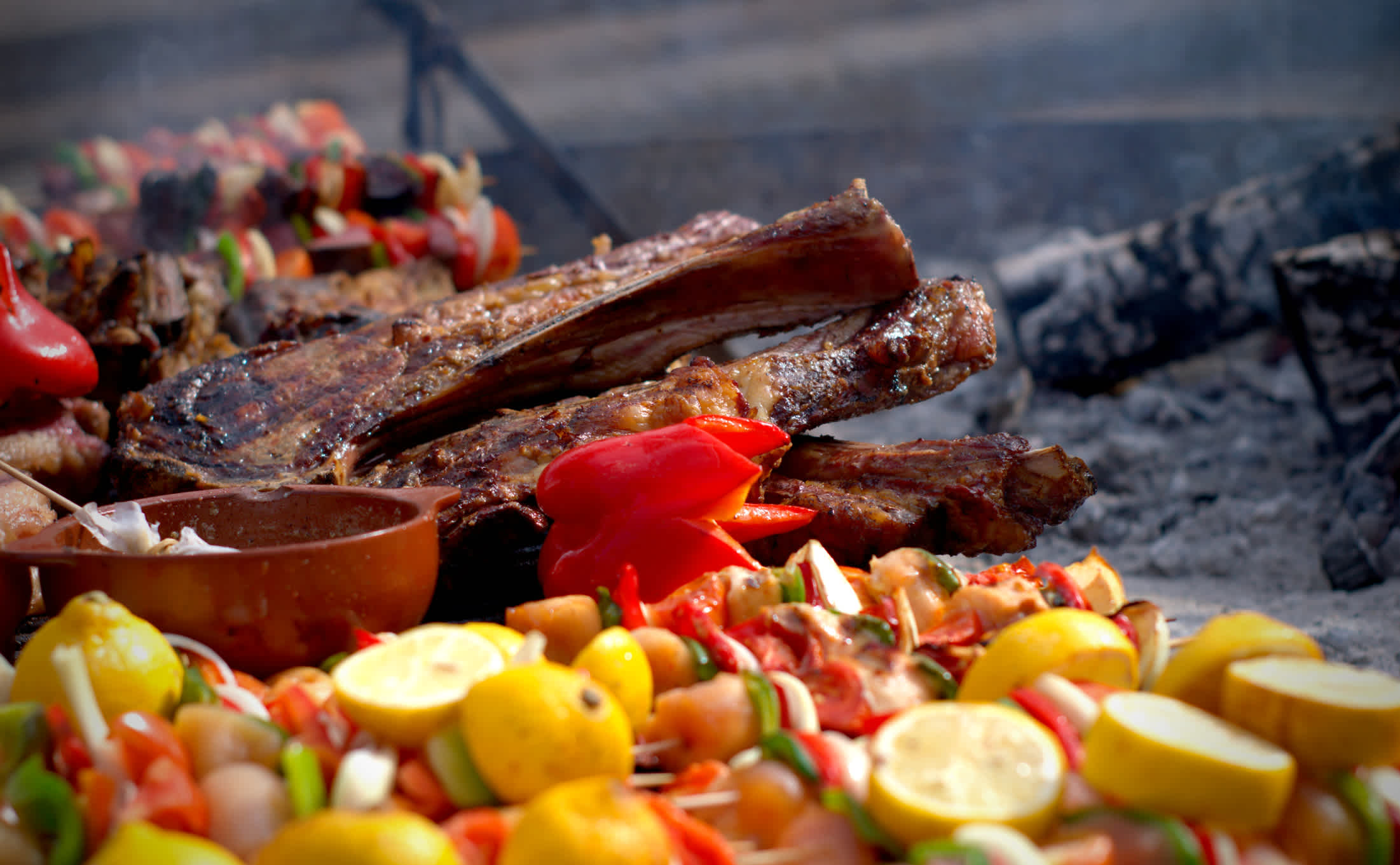 Grilled meat and vegetable skewers at a typical Argentinian asado (barbecue).
