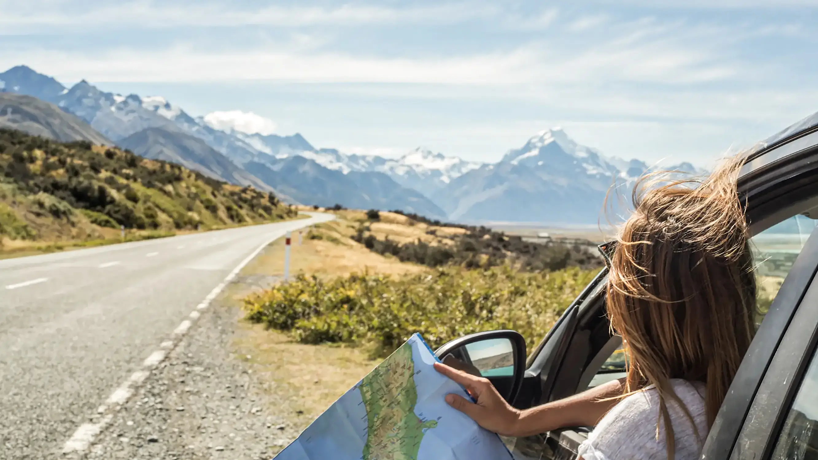 Neuseeland, Roadtrip Porträt von junge Frau im Auto schaut an Karte. Neuseeland.
