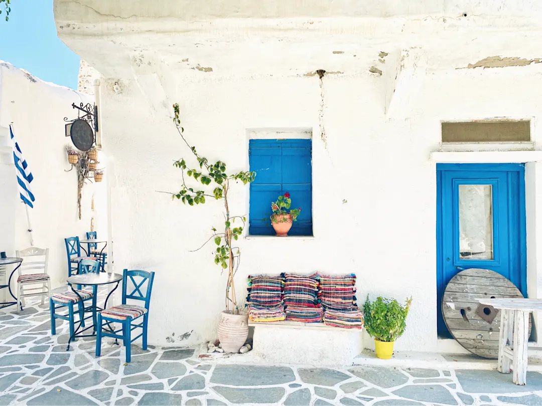 Traditionelle weiße Fassade mit blauer Tür und Fenster, dekoriert mit Pflanzen, Naxos, Kykladen, Griechenland