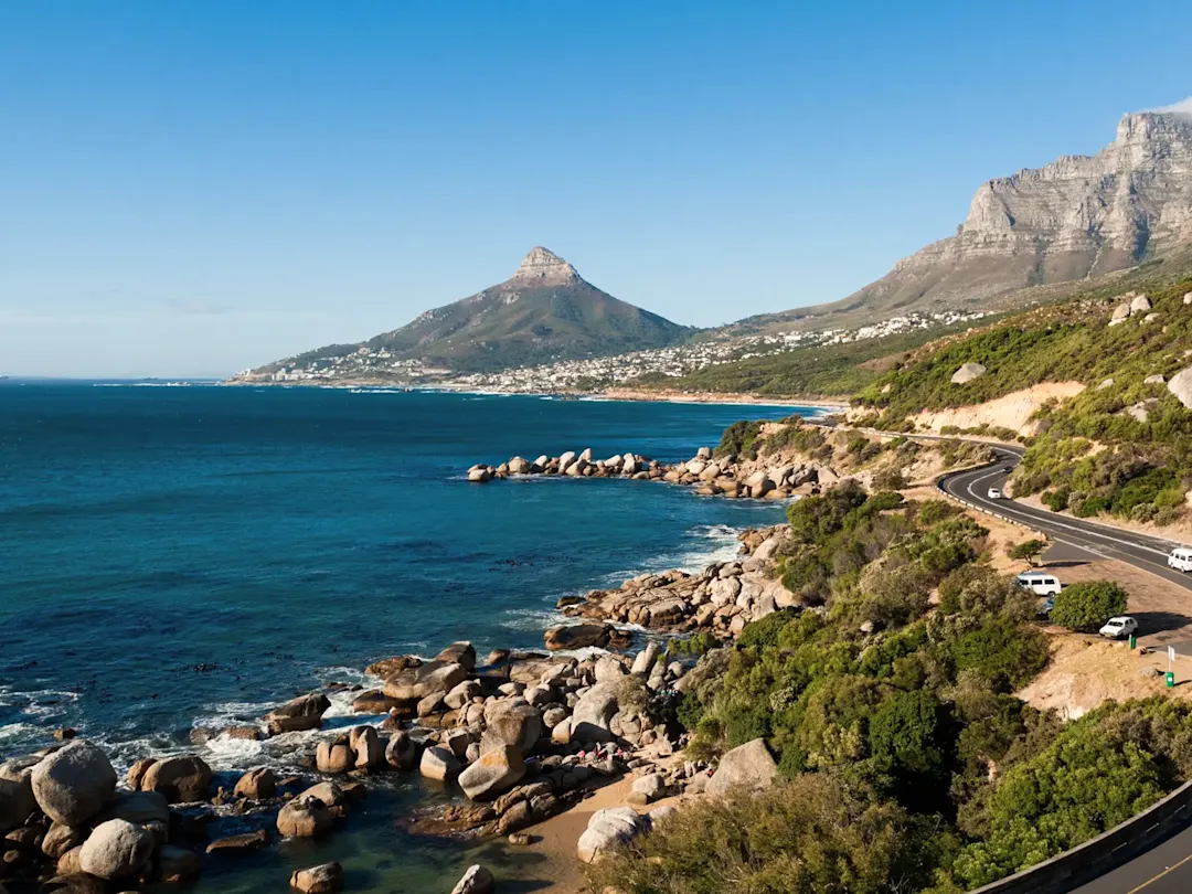Küstenstraße mit Blick auf das Meer und den Lions Head bei klarem Himmel. Kapstadt, Westkap, Südafrika.
