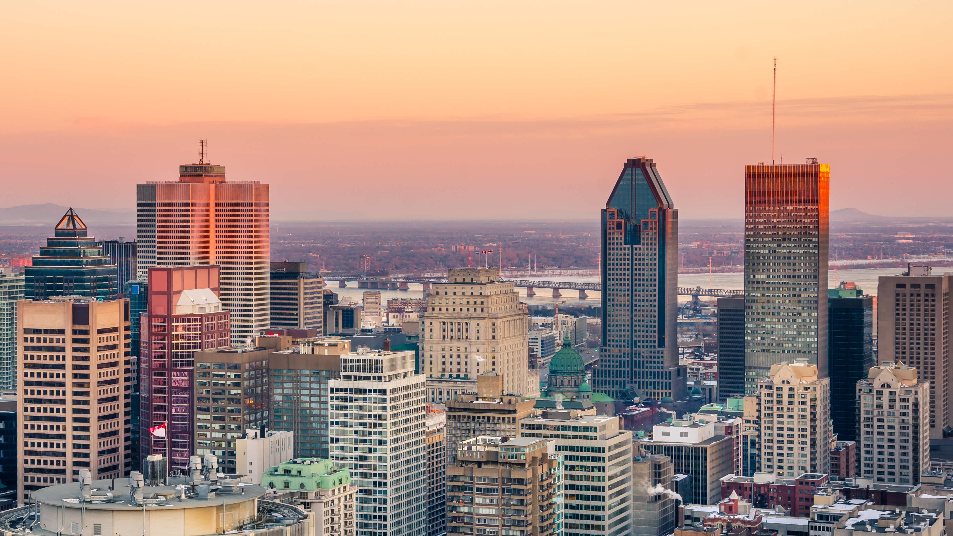 Vue aérienne sur la skyline de Montréal au coucher du soleil. Montréal est une des villes à visiter pendant votre voyage au Canada,