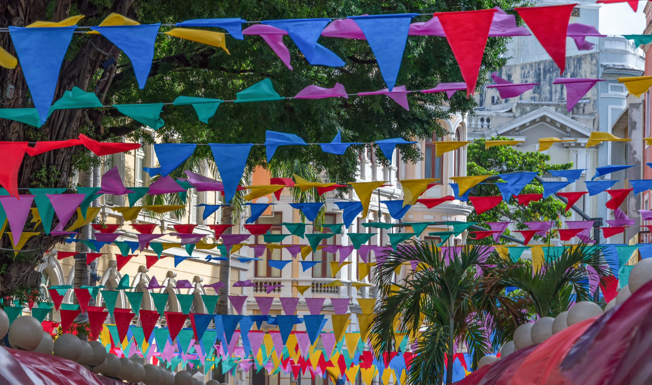 Colorful carnival decorations and palm trees. 