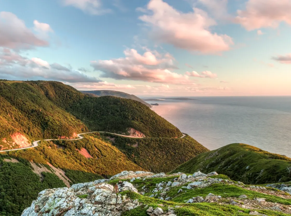 Die kurvenreiche Cabot Trail Straße von hoch oben auf dem Skyline Trail bei Sonnenuntergang im Cape Breton Highlands National Park, Nova Scotia

