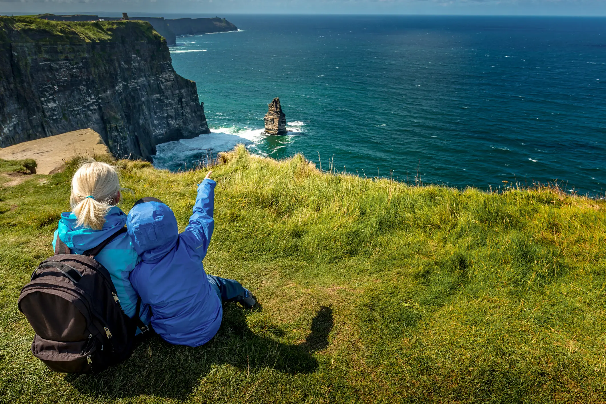 Woman and a child admire the view of Cliffs of Moher, County Clare, Ireland.