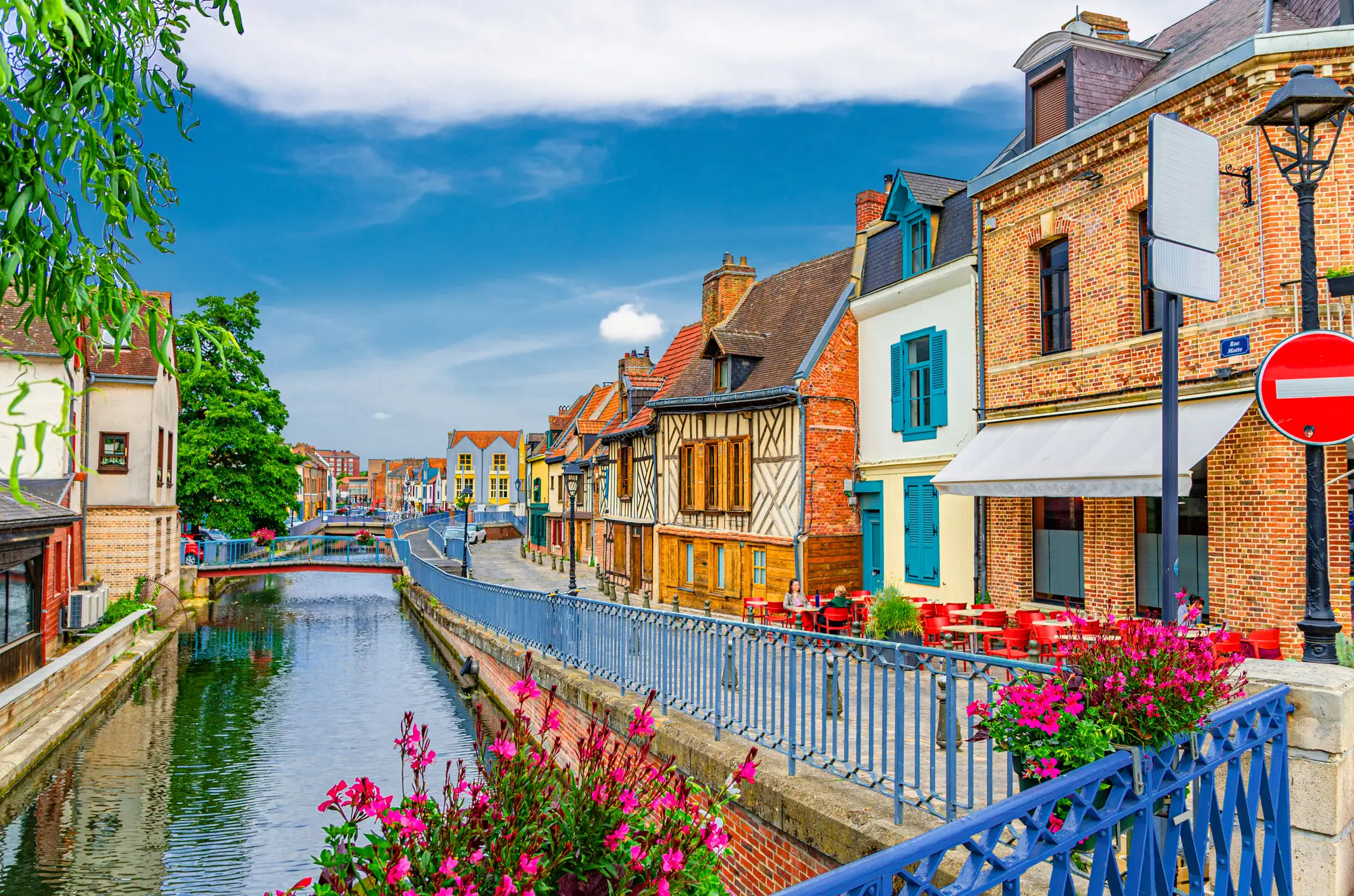 Saint-Leu quarter with traditional fachwerk houses and brick buildings on embankment of Somme river water canal with bridges in Amiens historical city centre, Hauts-de-France Region, Northern France