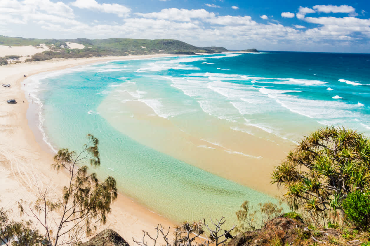 Enjoy a walk on an idyllic sandy beach during your Fraser Island Vacation.