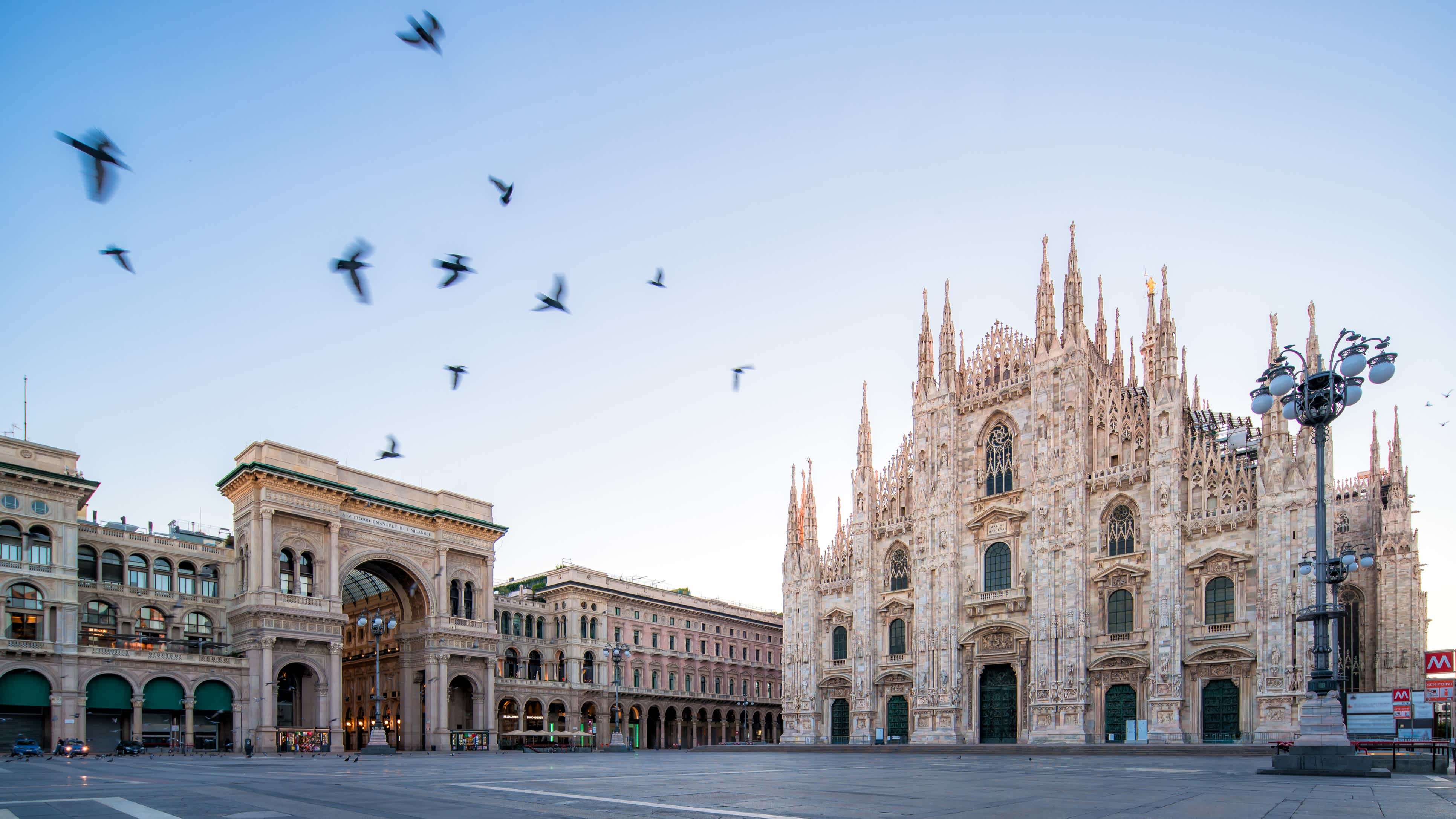 Sehen Sie die Piazza und die Fassade des Mailänder Doms im Morgengrauen, während eines Mailand-Urlaubs