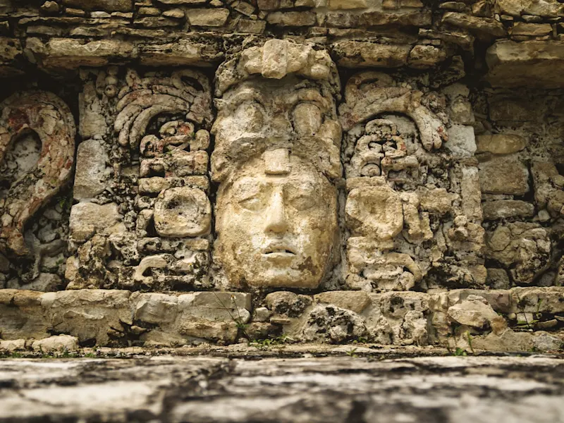 Palenque, Maya-Steinmaske, Mexiko Nahaufnahme einer alten Maya-Steinmaske mit detaillierter Verzierung. Palenque, Chiapas, Mexiko.