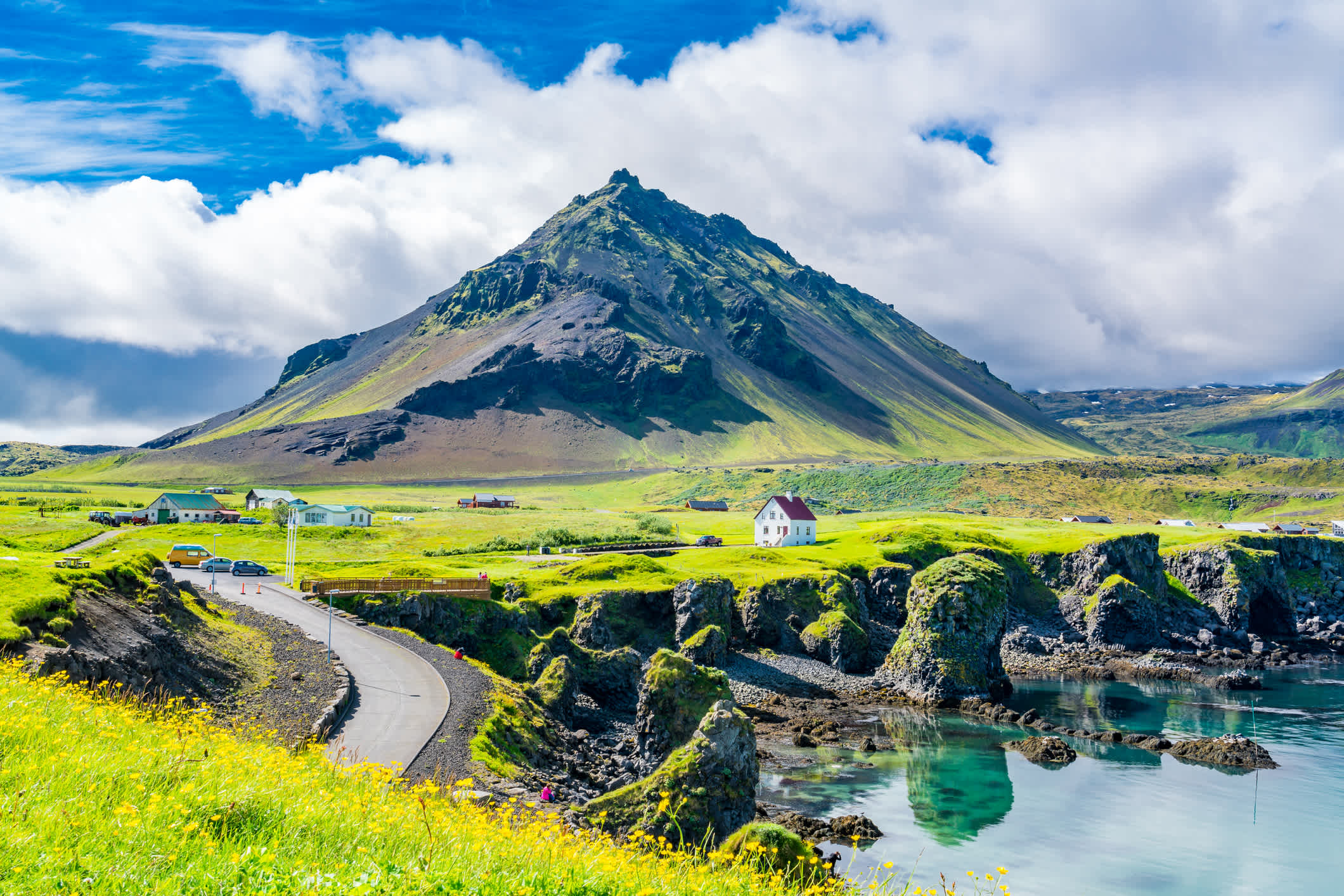 Arnarstapi Village in summer sunny day in Iceland. View at the Mountain Stapafell.