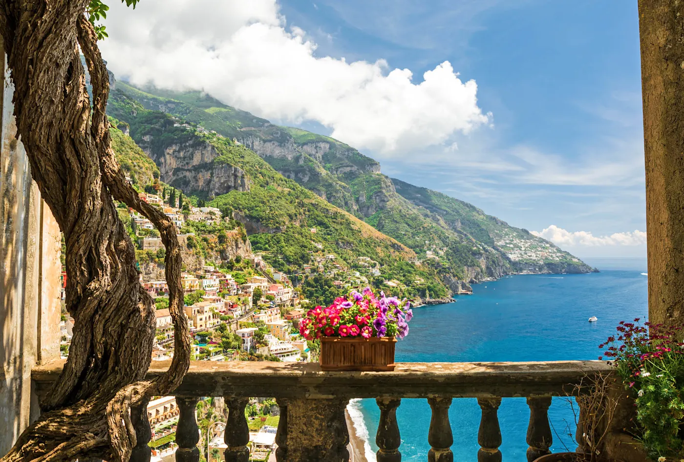 View of the town of Positano from antique terrace with flowers, Amalfi coast, Italy