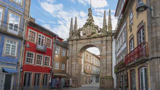 Blick auf den Arco de Porta Nova in Braga zwischen bunten Häusern