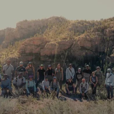 Group of people posing for a photo outside