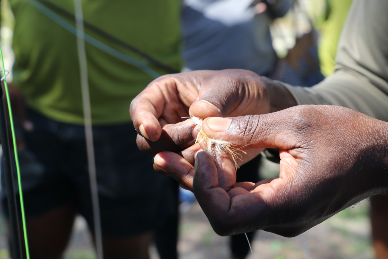 Closeup on hands tying flies