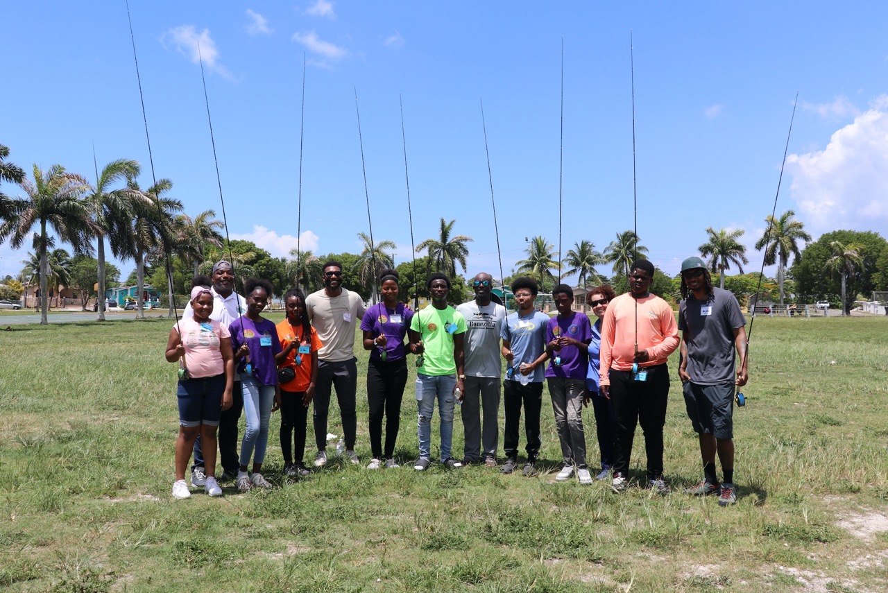 Group of community fly fishing participants holding fly rods
