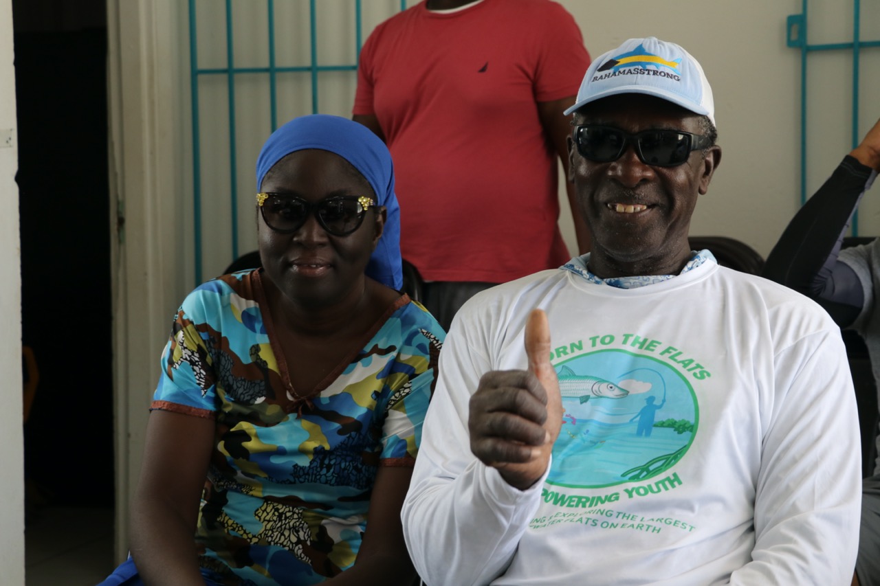Two community fly fishing participants, one giving a thumbs up