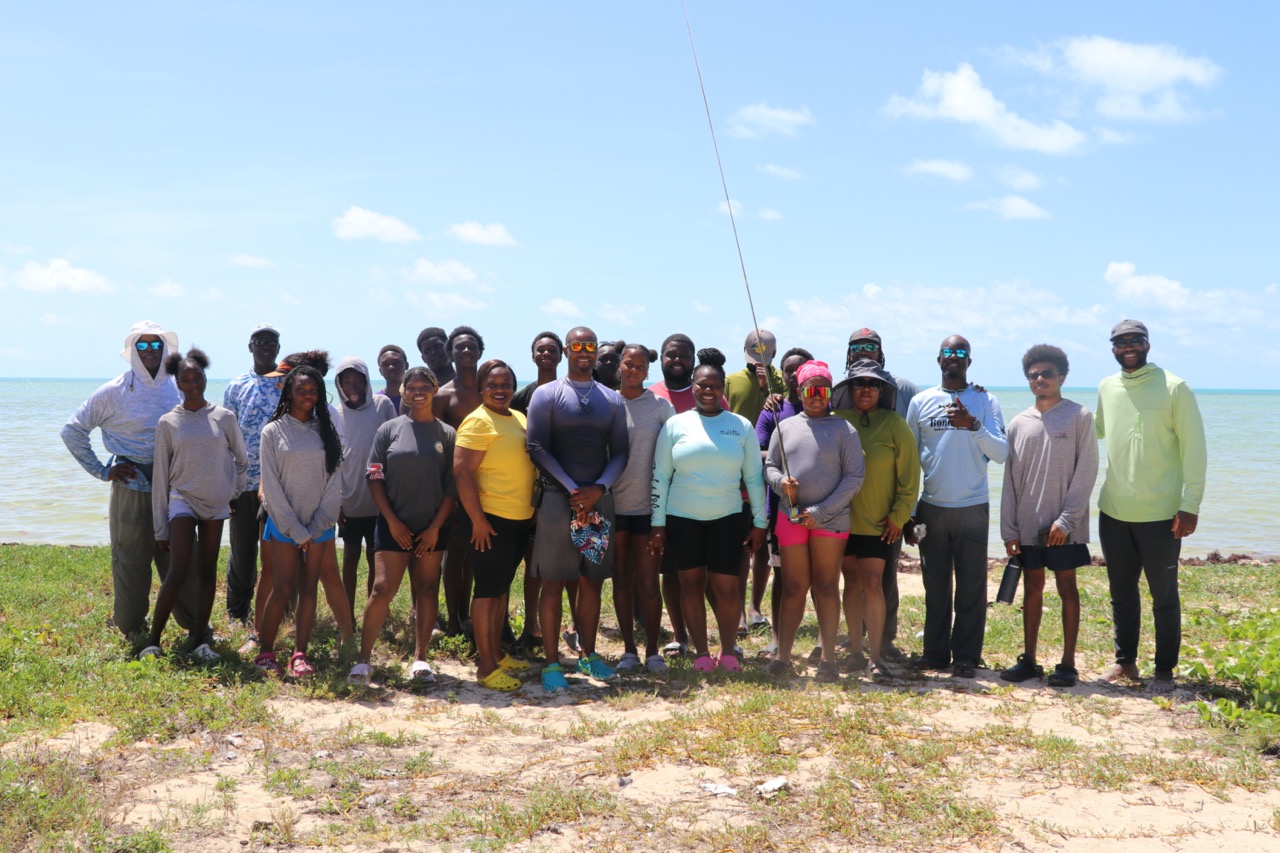 Group of community fly fishing attendees on the beach in the Bahamas