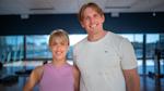Two friends smiling, wearing gym clothes