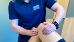Physiotherapist treating knee