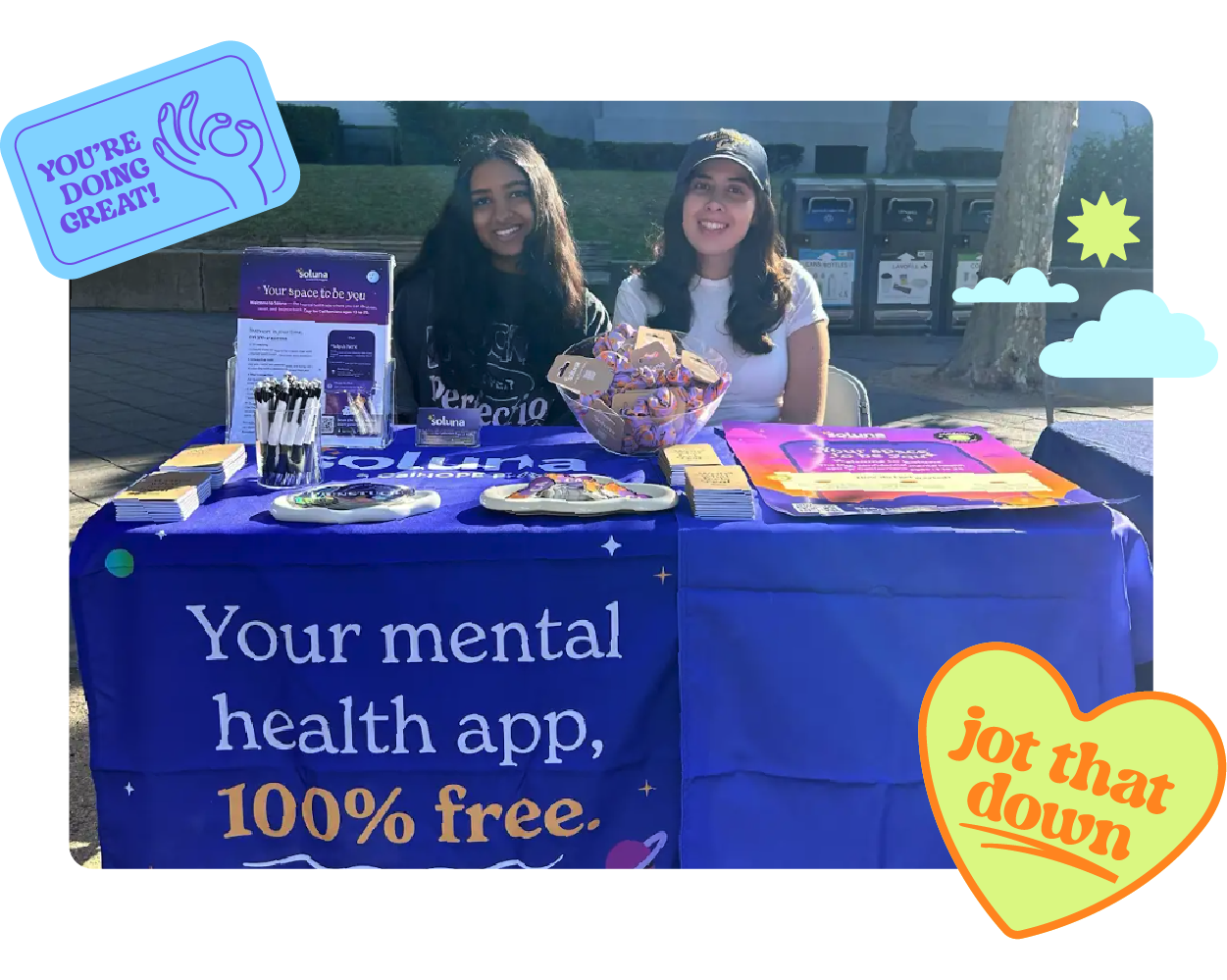 An image of two college-aged students at a Soluna table handing out materials.