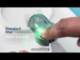 Person pressing and holding the standard/original filter button inside pitcher lid for 5 seconds, to reset the standard filter indicator.