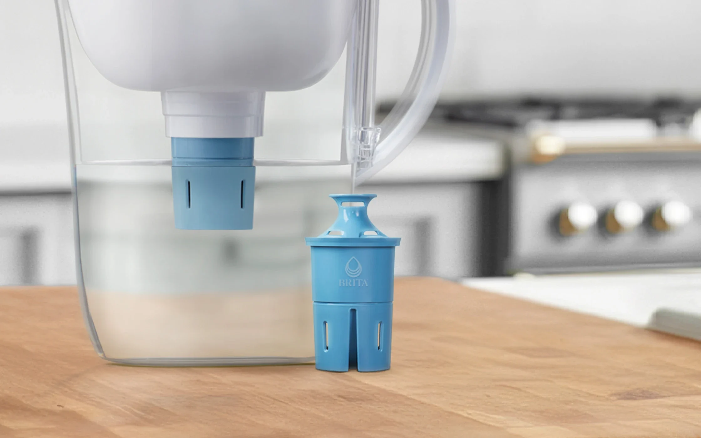 Elite Replacement Filter next to Brita pitcher with Elite filter installed, sitting on kitchen island.