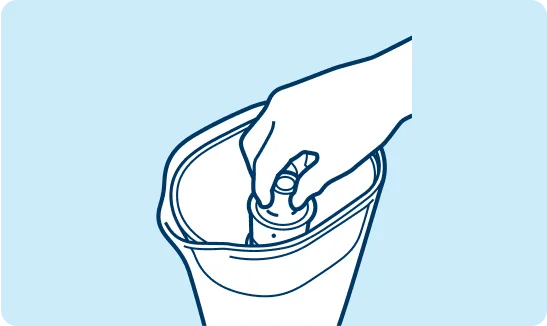 Hand inserting filter into reservoir inside water pitcher.