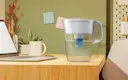 White Tahoe Water Pitcher with Elite Filter sitting on desk in dorm room.