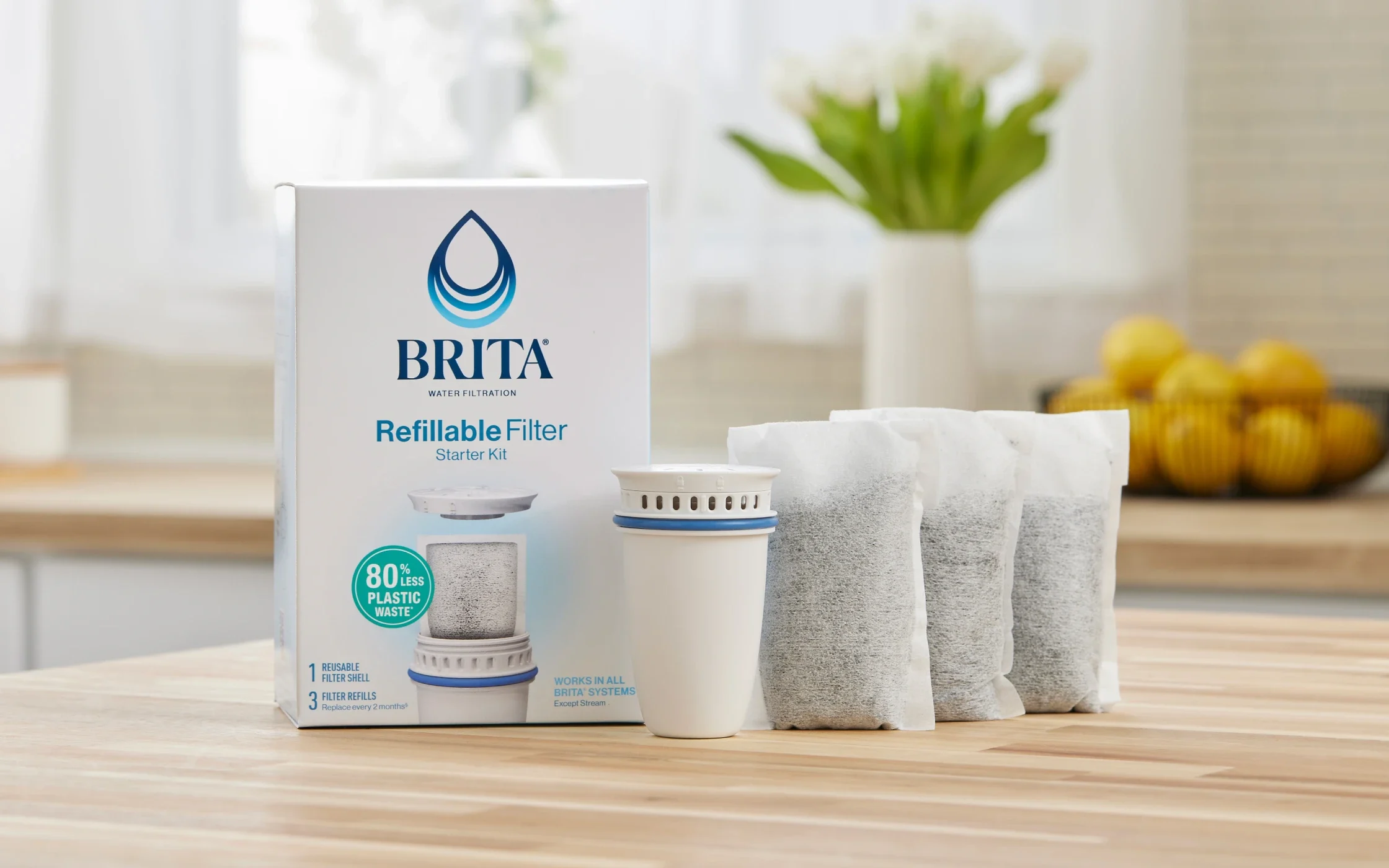 Brita® Refillable Water Filtration Starter Kit with 1 Reusable Filter Shell and 3 Filter Refills shown on kitchen island.