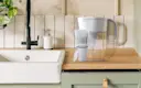 Brita® Refillable Water Filtration System with White Tahoe Water Pitcher and 1 Refillable Filter on kitchen counter.