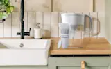 Brita® Refillable Water Filtration System with White Tahoe Water Pitcher and 1 Refillable Filter on kitchen counter.