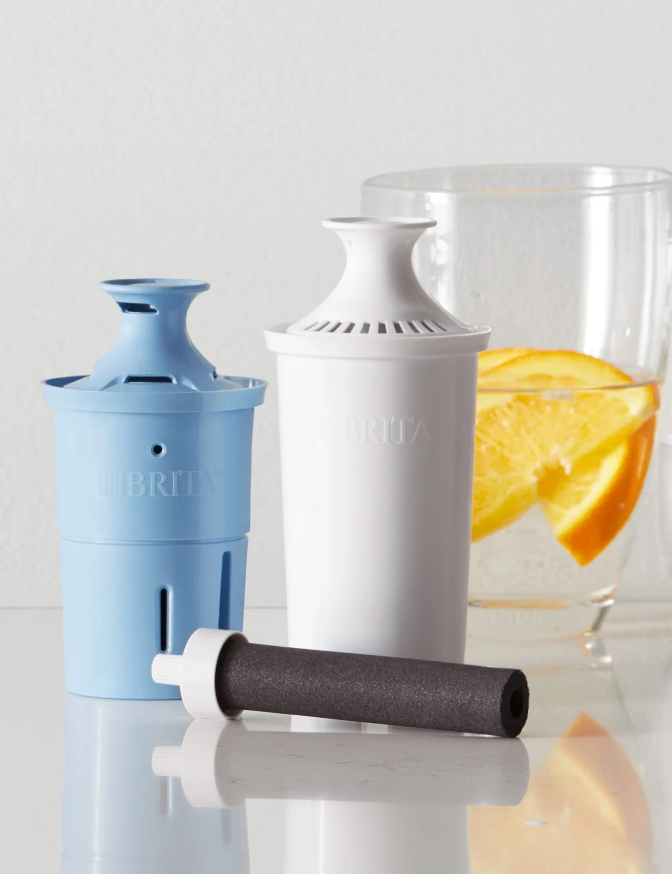 Brita Elite Filter, Original Filter, and Bottle filter on counter, next to two water glasses.