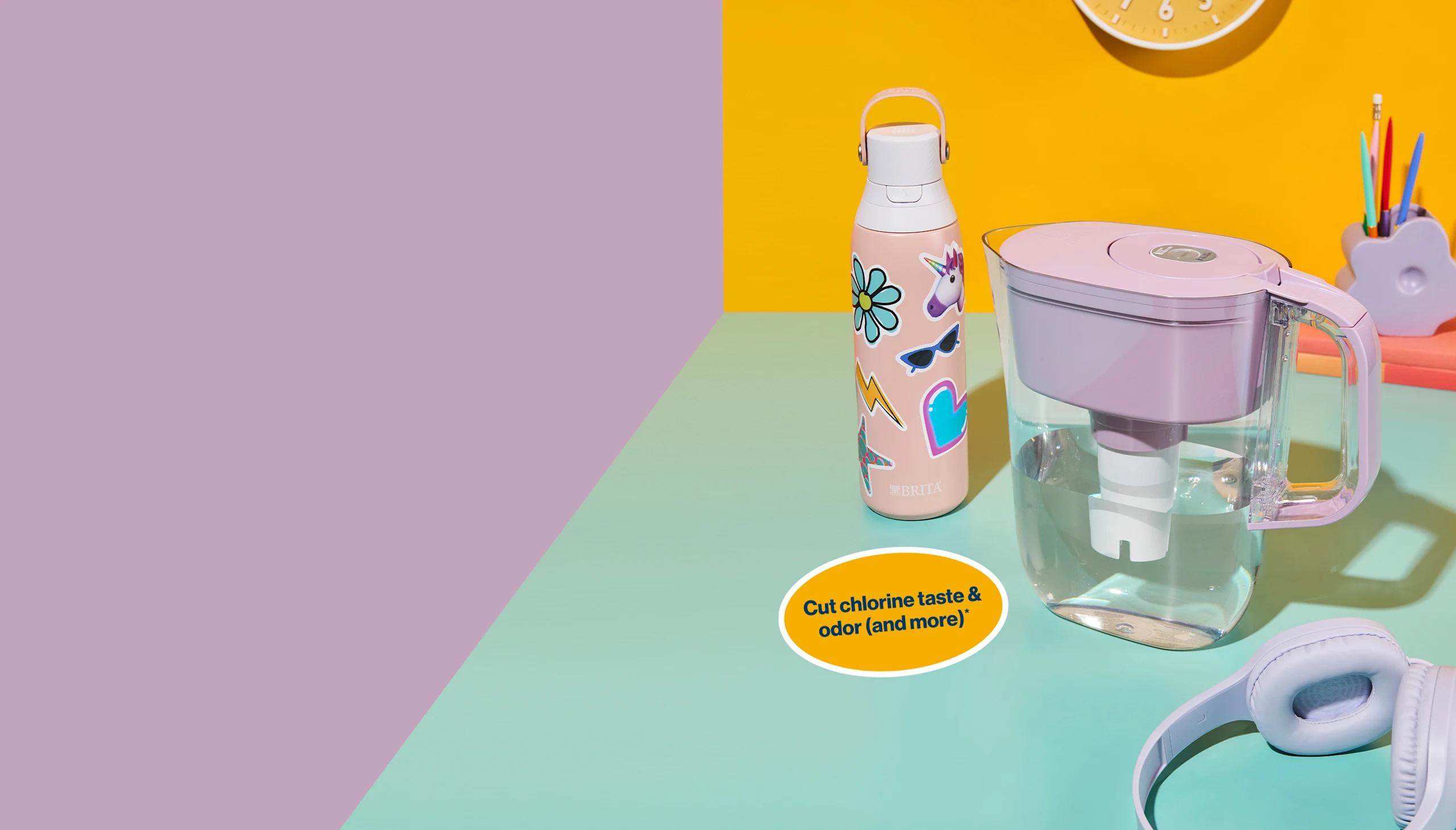 Rose colored stainless steel Brita water bottle covered in stickers on desk next to Lilac colored Brita pitcher. Cut chlorine taste & odor (and more).