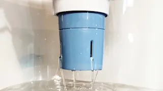 Brita Elite filter, installed into pitcher with water filtering through the filter into pitcher.