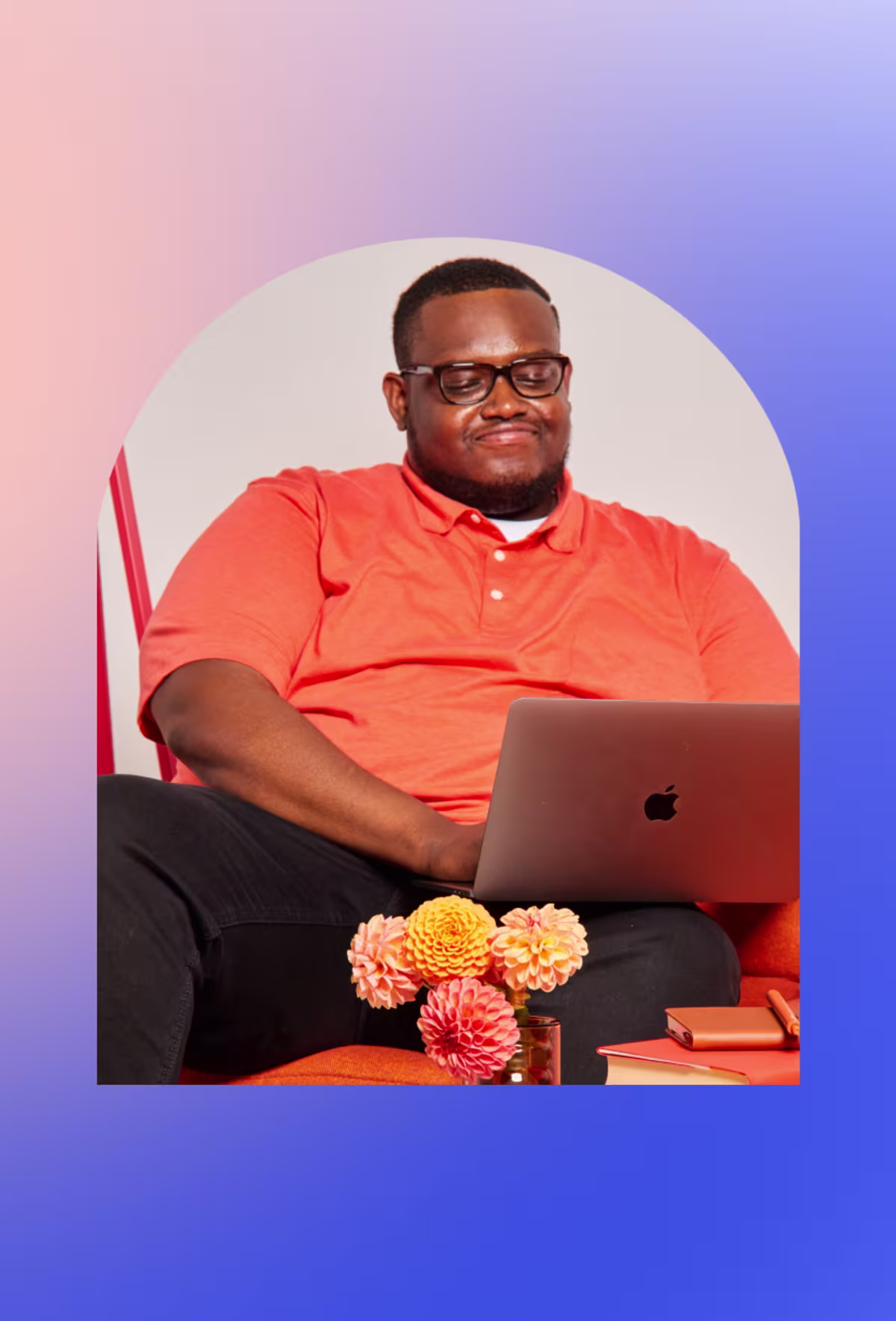 Image of a smiling man with a laptop