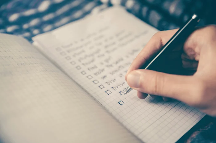 A person checks an item on a todo list