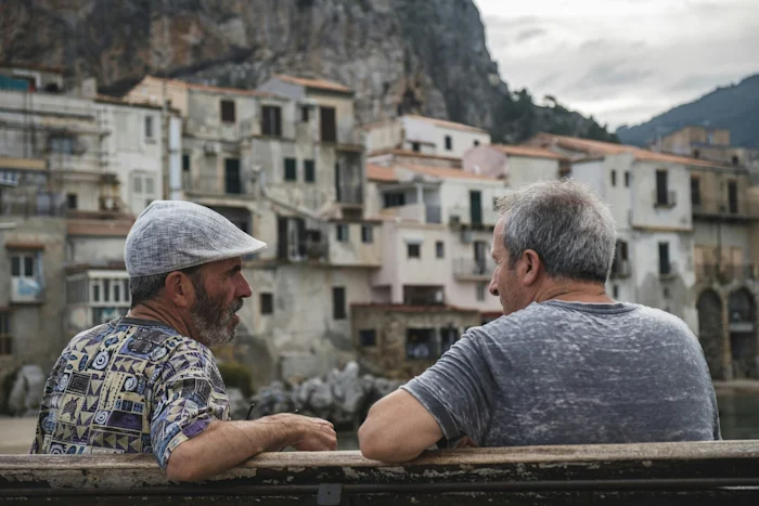 Two men chatting on a bench