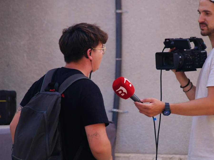 A TV network interviewing a man on the street