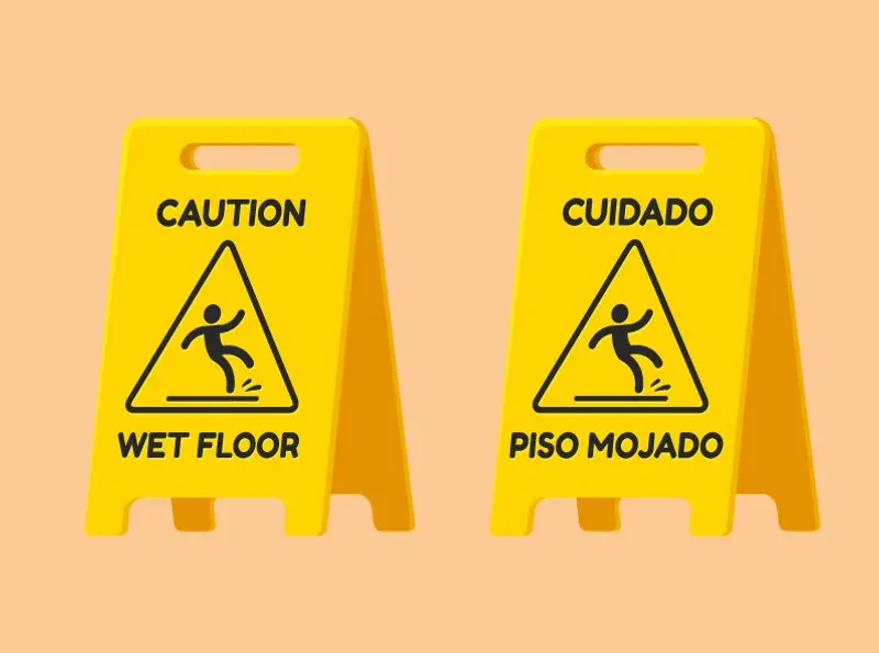 Wet floor caution signs in English and Spanish