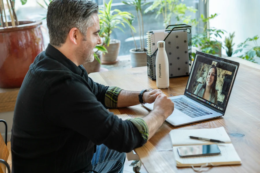 A man on a Zoom call with a woman