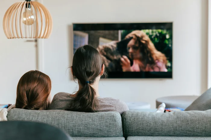 Two women watching a movie at home