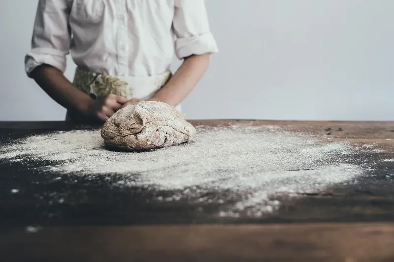 A person making pizza dough