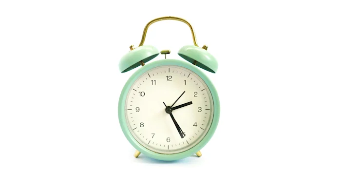 A mint green alarm clock