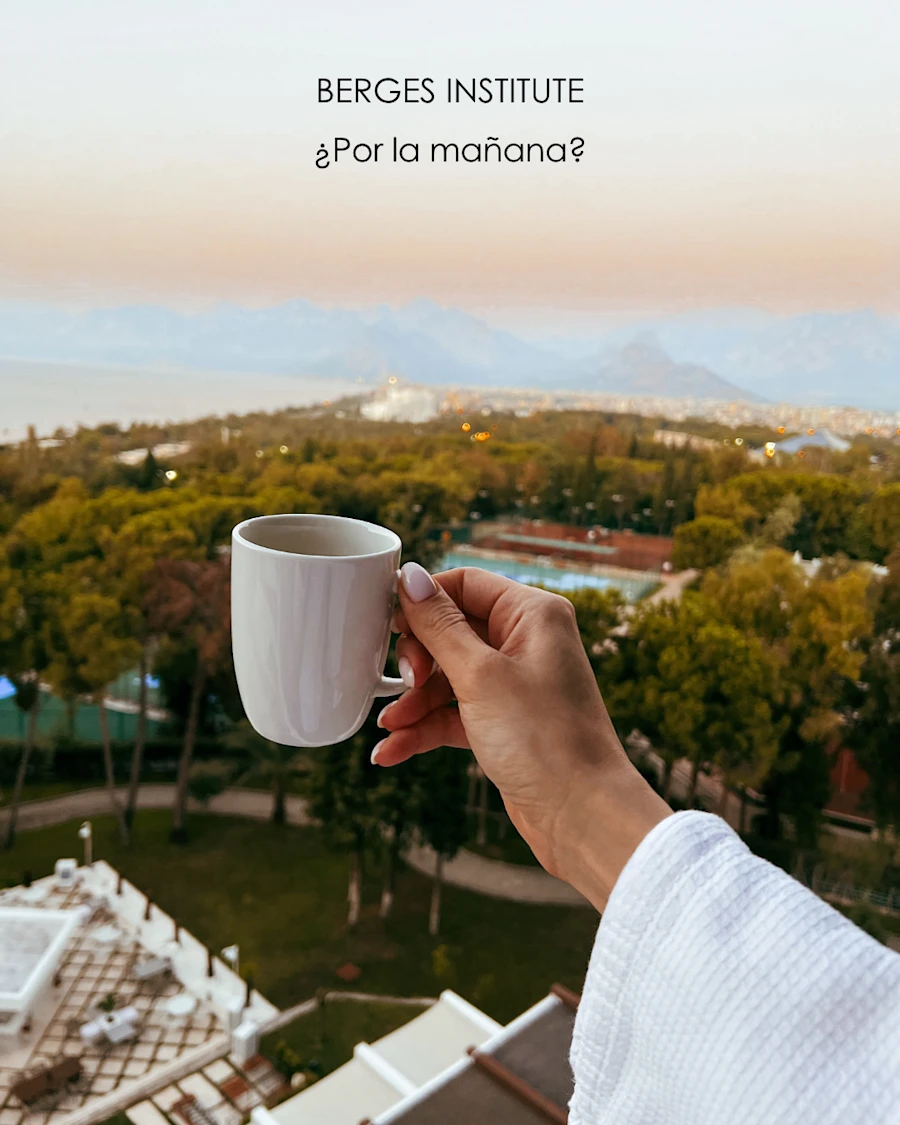 A hand holding a coffee in the morning