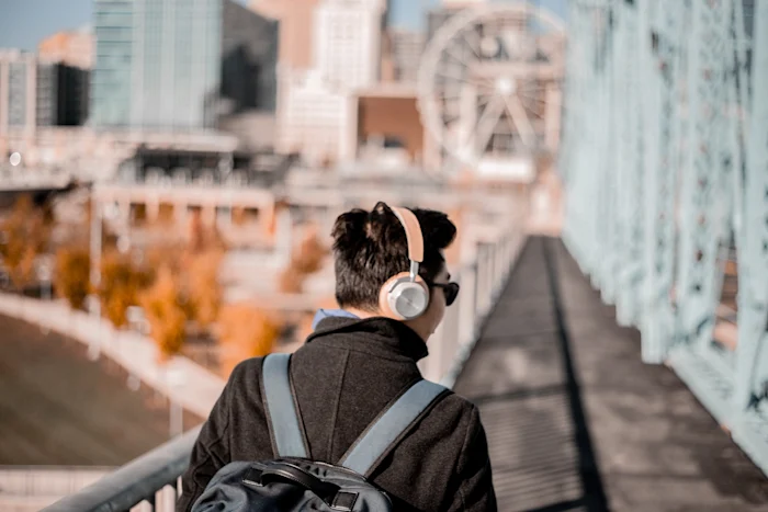 A man wearing pink headphones